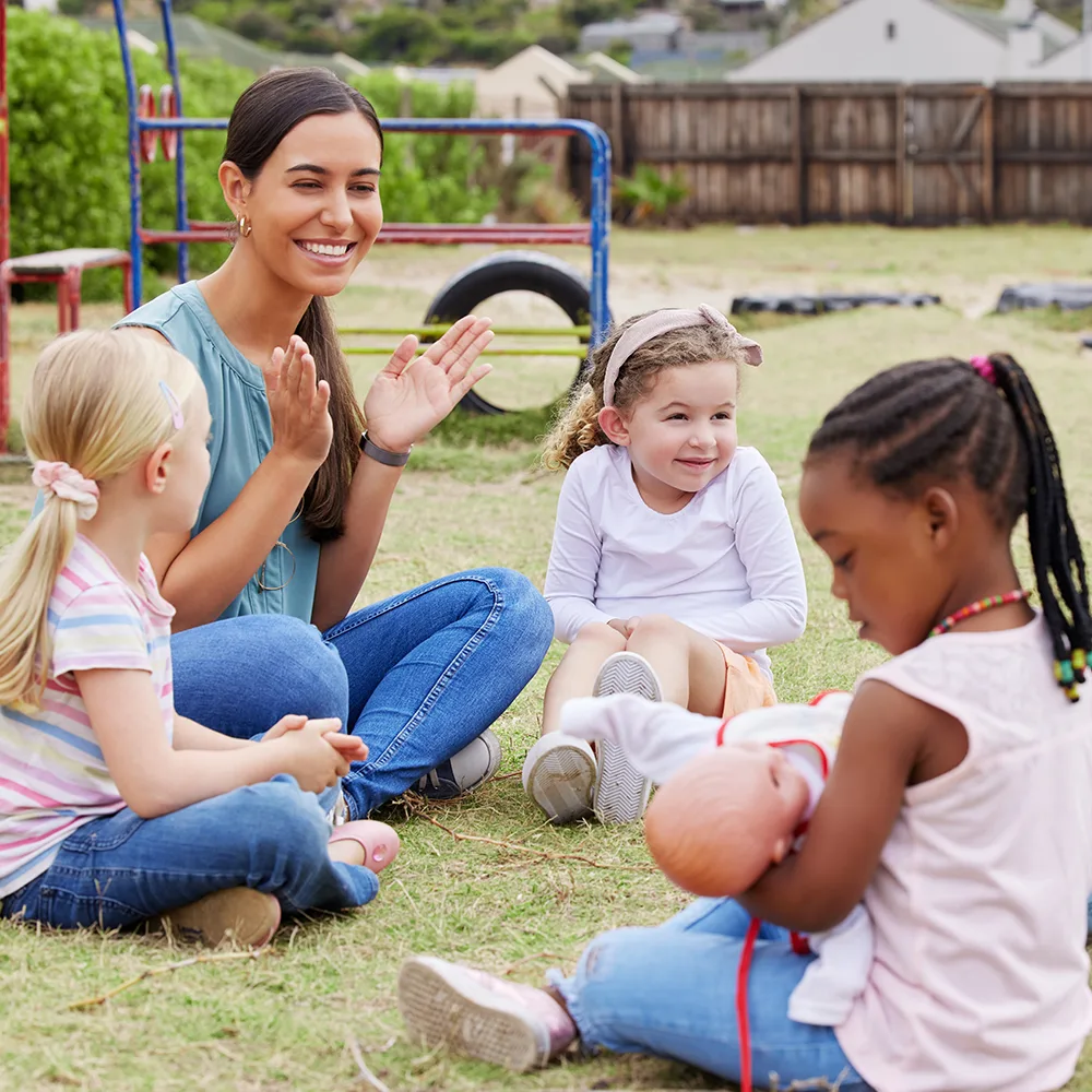 Preschool teacher outside with kids