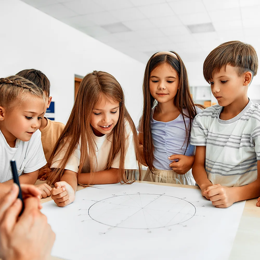 5 children standing around a drawing at a table at Little Sprouts daycare
