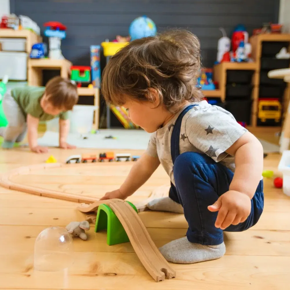 A child playing with a ramp at a Little Sprouts daycare