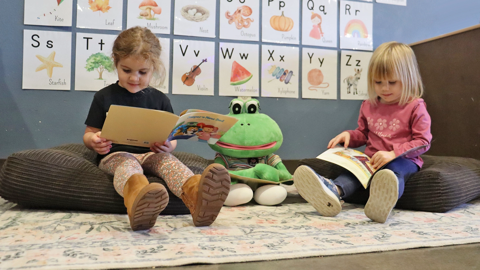 Two children reading next to a stuffed animal at a Little Sprouts daycare