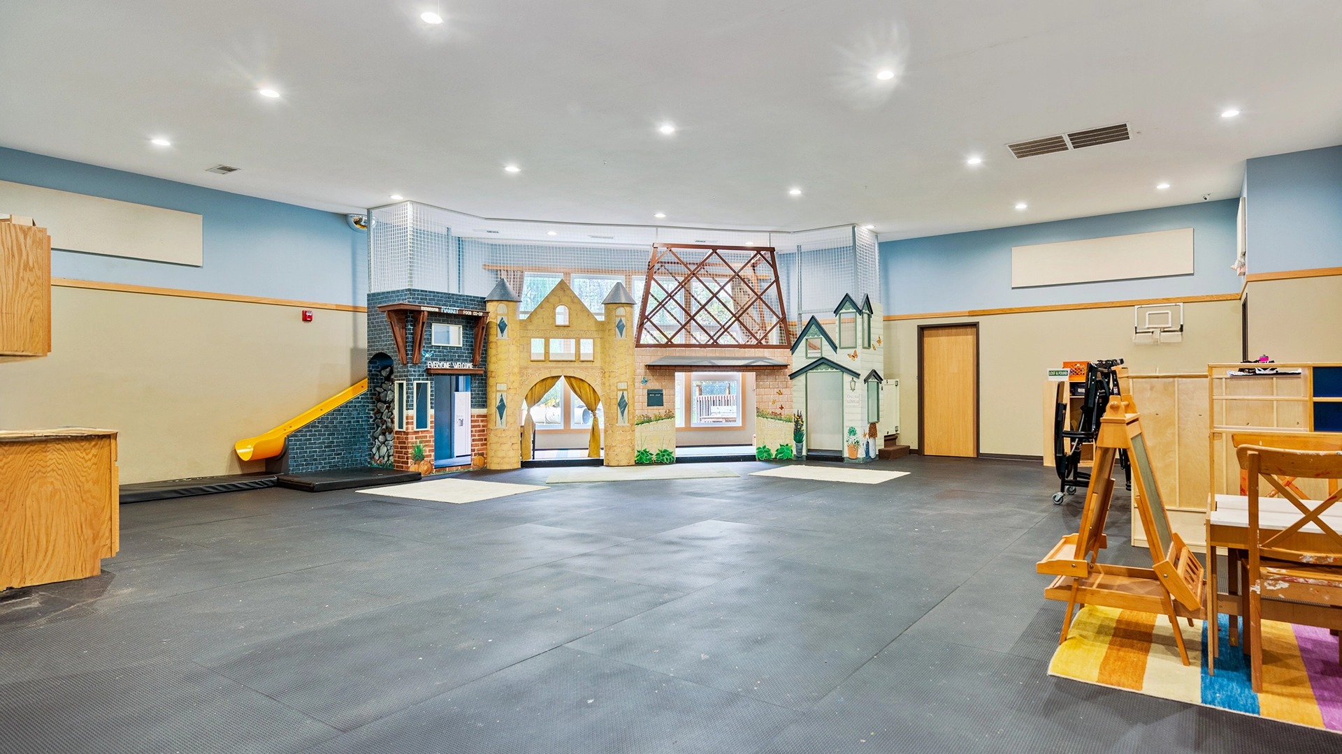 A large indoor play area at a Little Sprouts daycare