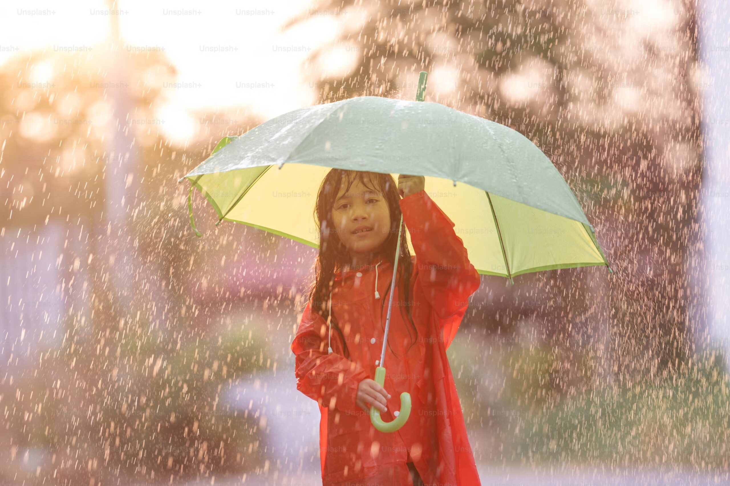 kid with umbrella outside during rainy day