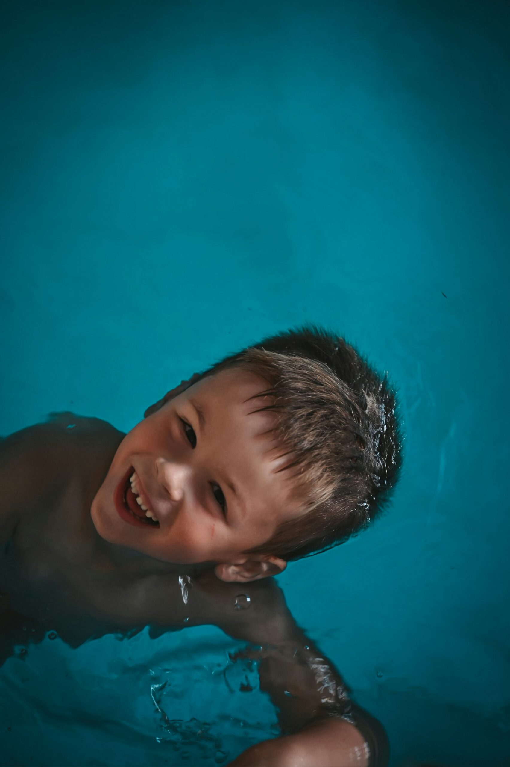 Toddler boy in a pool